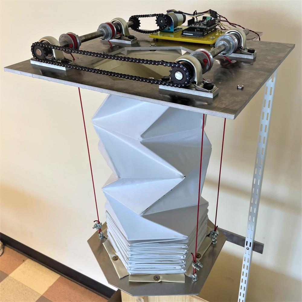 An expanding and contracting chute based on the origami driven Kresling pattern, designed specifically to deliver retardant foam to wildland fires.